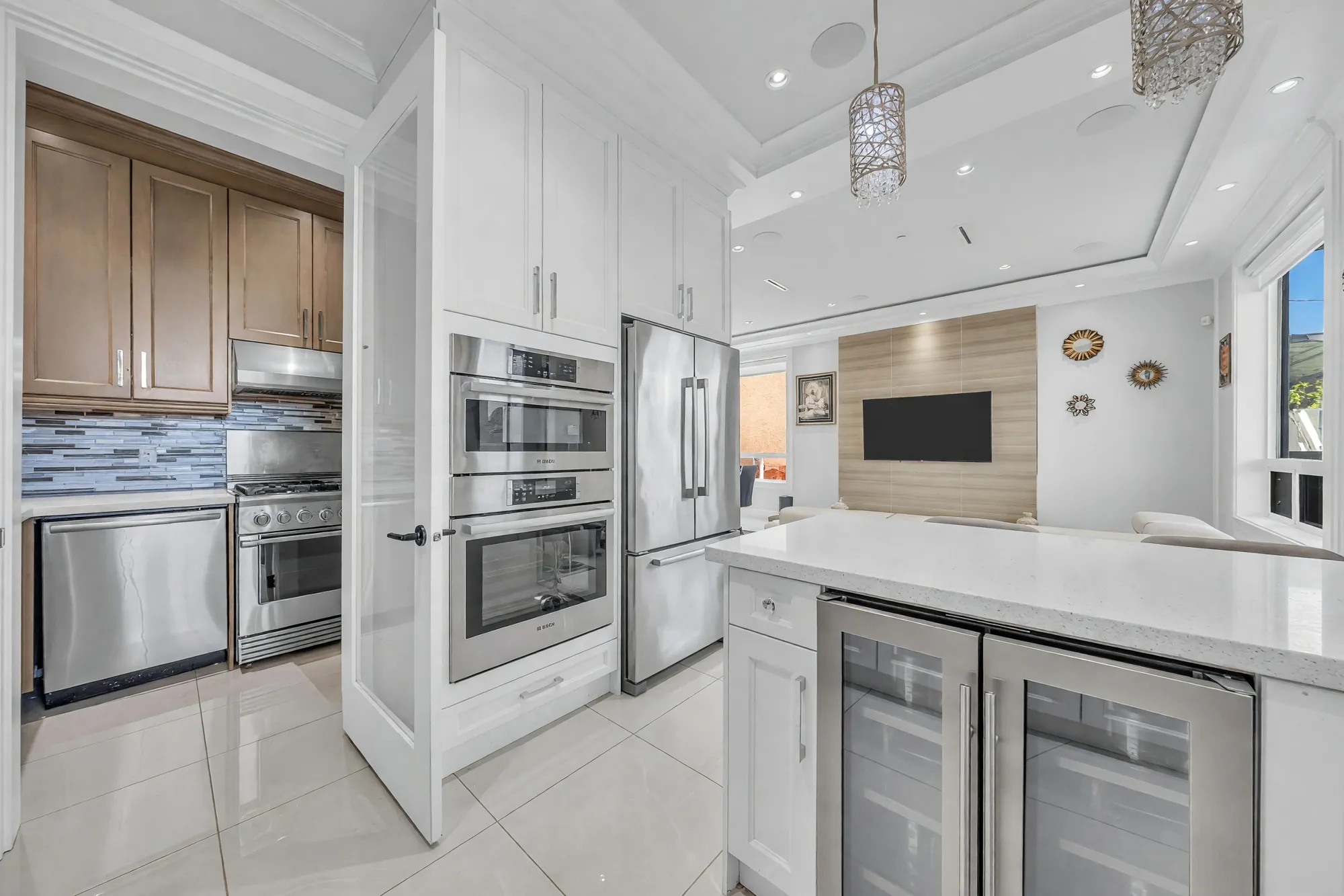 From the wok kitchen's door into the kitchen: the wine fridge under the counter, the ovens, the family room beyond
